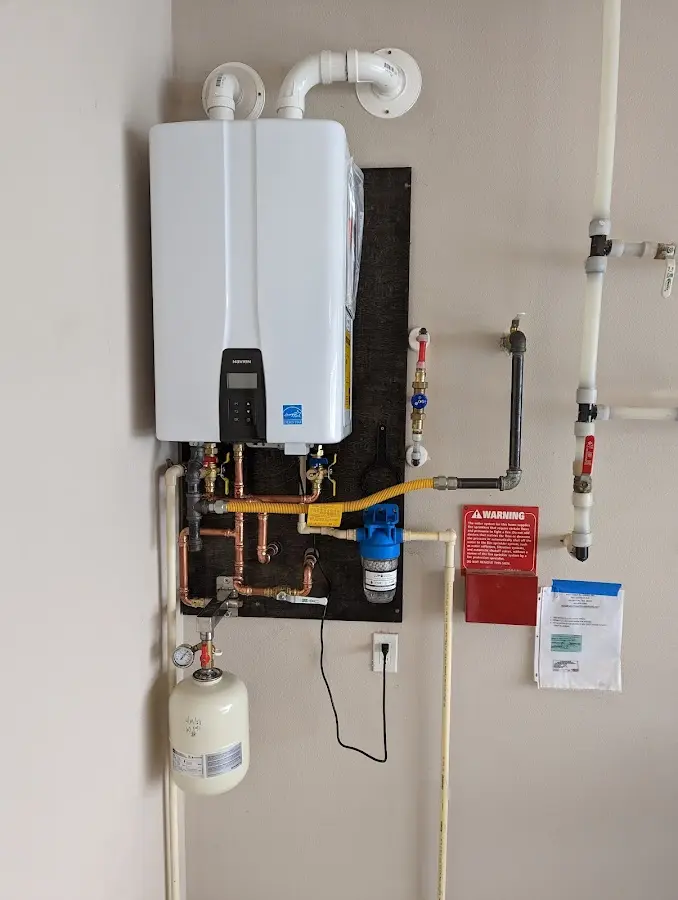 Professional plumber installing copper piping in a Parkwood home